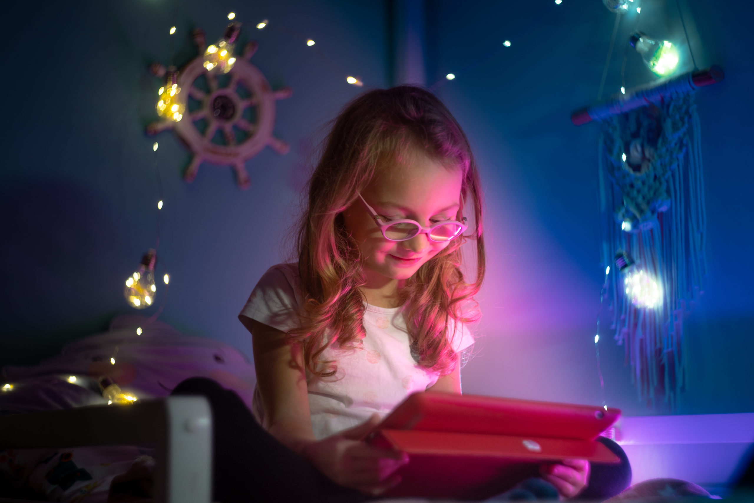 Child playing iPad in Space